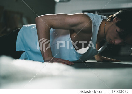 Man doing push-ups in his garage 117038082