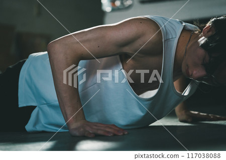 Man doing push-ups in his garage 117038088