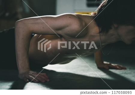 Man doing push-ups in his garage 117038093