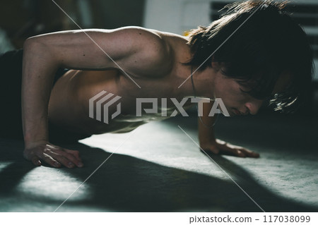 Man doing push-ups in his garage 117038099