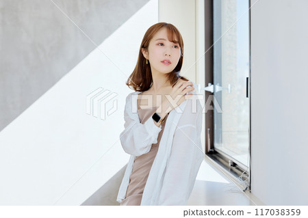 Woman by the window 117038359