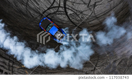 Aerial top view car drifting diffusion race drift car with lots of smoke from burning tires on speed track, Professional driver drifting car with lots of white smoke. Aerial top view car drifting diffusion race drift car with lots of smoke from burning tires on speed track, Professional driver drifting car with lots of white smoke. 117038743