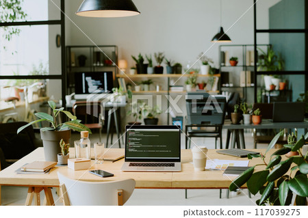 No people shot of part of modern eco-friendly office interior with biophilic design, equipped with computers and peripheral devices 117039275