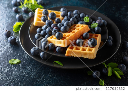 Belgian waffles with blueberries. 117039832