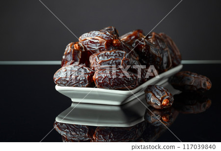 Dates on a black reflective background. Dates on a black reflective background. 117039840