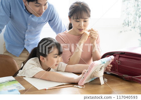 Parents and daughter looking at a tablet Parents and daughter looking at a tablet 117040593