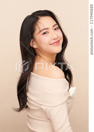 Beautiful young asian woman with clean fresh skin on beige background, Face care, Facial treatment, Cosmetology, beauty and spa, Asian women portrait. 117040880