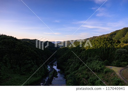 Scenery of Nunome Dam on the eastern edge of Nara City. Evening sky on the valley side and Nunome River. Fixed tripod interval photography from before sunset to the night sky #24 117040941