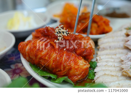 Korean traditional food with thinly sliced boiled pork and freshly made cabbage kimchi Korean traditional food with thinly sliced boiled pork and freshly made cabbage kimchi 117041000