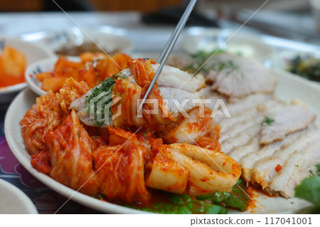 Korean traditional food with thinly sliced boiled pork and freshly made cabbage kimchi 117041001