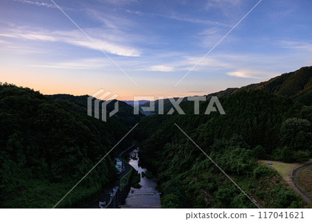 Scenery of Nunome Dam on the eastern edge of Nara City. Evening sky on the valley side and Nunome River. Fixed tripod interval photography from before sunset to the night sky. Scenery of Nunome Dam on the eastern edge of Nara City. Evening sky on the valley side and Nunome River. Fixed tripod interval photography from before sunset to the night sky. 117041621