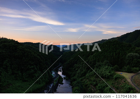Scenery of Nunome Dam on the eastern edge of Nara City. Evening sky on the valley side and Nunome River. Fixed tripod interval photography from before sunset to the night sky. Scenery of Nunome Dam on the eastern edge of Nara City. Evening sky on the valley side and Nunome River. Fixed tripod interval photography from before sunset to the night sky. 117041636