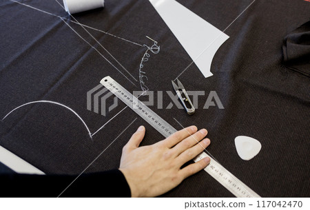 male tailor works in atelier. male tailor works in atelier. 117042470