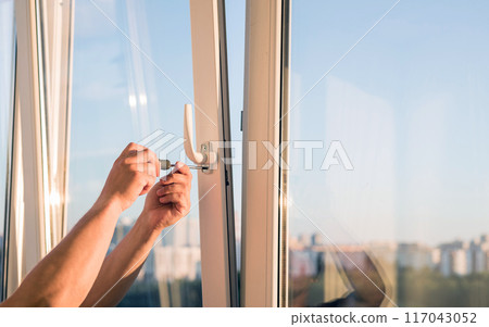 hands adjust the plastic window 117043052