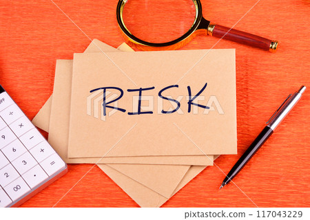 Risk management concept. RISK word on a postal envelope on an orange background Risk management concept. RISK word on a postal envelope on an orange background 117043229