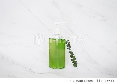 Bottle of liquid soap. The bottle is green and clear, and the soap is in a pump dispenser. Concept of cleanliness and freshness 117043633