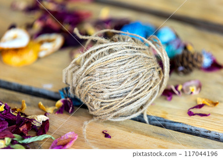 Close-up roll of brown jute twine for crafting Close-up roll of brown jute twine for crafting 117044196