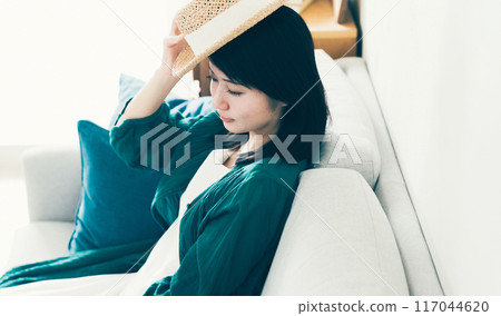 A woman wearing a straw hat 117044620