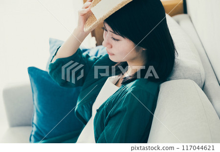 A woman wearing a straw hat 117044621