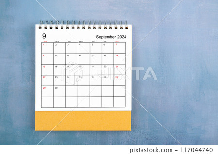 Directly above view of September 2024 desk calendar on blue wooden background. Directly above view of September 2024 desk calendar on blue wooden background. 117044740
