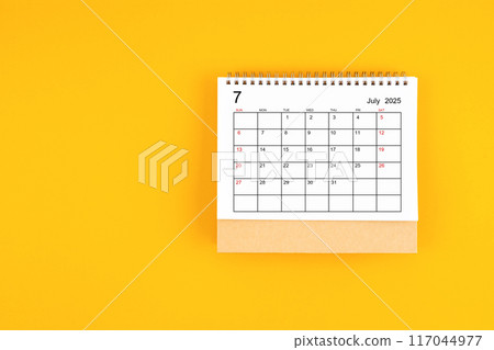 July 2025 desk calendar on yellow color background, position with copy space. 117044977