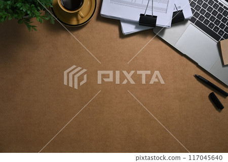 Financial reports, laptop and cup of coffee on brown background. Top view Financial reports, laptop and cup of coffee on brown background. Top view 117045640