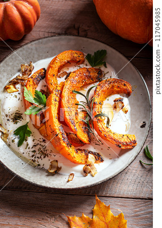 Roasted pumpkin with greek yogurt and herbs Roasted pumpkin with greek yogurt and herbs 117045985
