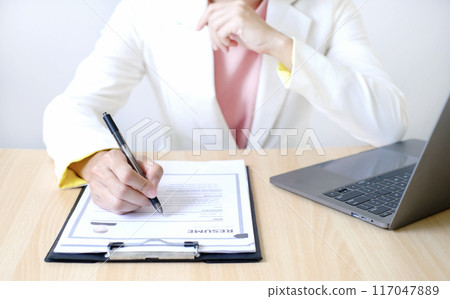 Business woman employer holding resume hiring recruit looking cv resume to hire candidates, analyzing information before job interview. Recruitment concepts Business woman employer holding resume hiring recruit looking cv resume to hire candidates, analyzing information before job interview. Recruitment concepts 117047889
