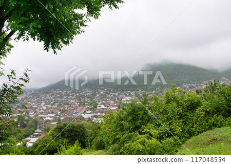 View of Shaki City in Azerbaijan Under Cloudy Skies Surrounded by Lush Greenery View of Shaki City in Azerbaijan Under Cloudy Skies Surrounded by Lush Greenery 117048554