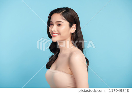 Beautiful Young transgender woman with clean fresh skin on blue background, Face care, Facial treatment, Cosmetology, beauty and spa, transgender women portrait. Beautiful Young transgender woman with clean fresh skin on blue background, Face care, Facial treatment, Cosmetology, beauty and spa, transgender women portrait. 117049848