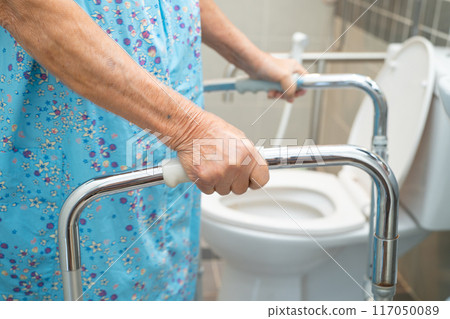 Asian elderly woman patient use walker and toilet bathroom handle security in nursing hospital, healthy strong medical. 117050089