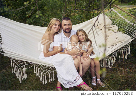 family mother father sister teenager and baby in hammock 117050298