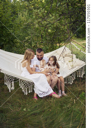 family mother father sister teenager and baby in hammock family mother father sister teenager and baby in hammock 117050301