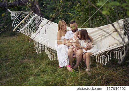 family mother father sister teenager and baby in hammock 117050302