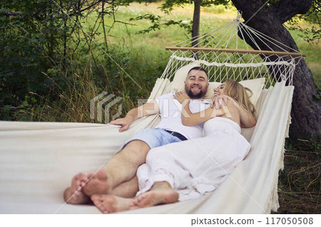 a loving couple in hammock, millennials a loving couple in hammock, millennials 117050508