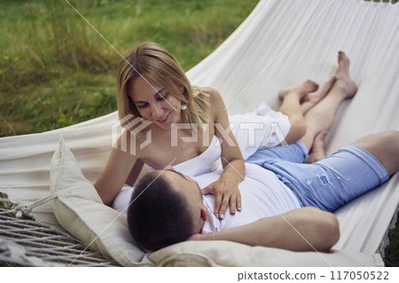 a loving couple in hammock, millennials a loving couple in hammock, millennials 117050522