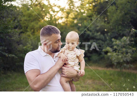 dad playing with his baby daughter in the garden dad playing with his baby daughter in the garden 117050543