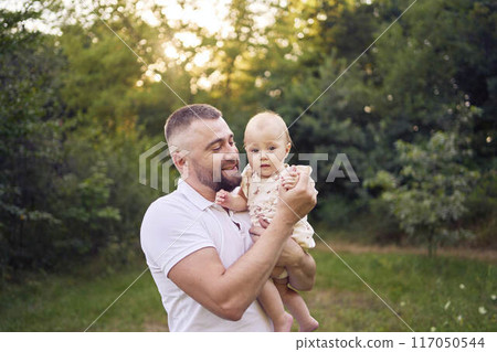 dad playing with his baby daughter in the garden dad playing with his baby daughter in the garden 117050544
