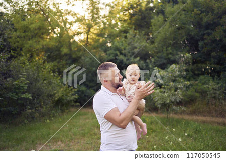 dad playing with his baby daughter in the garden dad playing with his baby daughter in the garden 117050545
