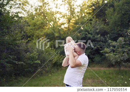 dad playing with his baby daughter in the garden 117050554
