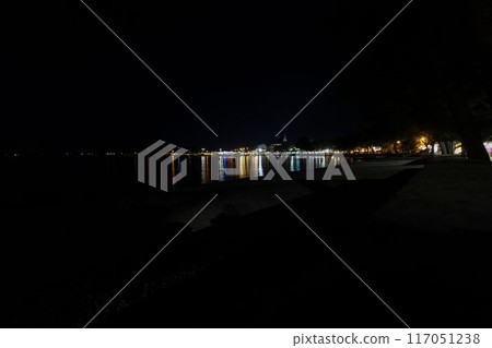Night picture over the beach and the illuminated town of Fazana in Istria Night picture over the beach and the illuminated town of Fazana in Istria 117051238