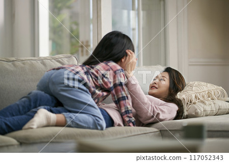 asian mother and daughter chatting at home asian mother and daughter chatting at home 117052343