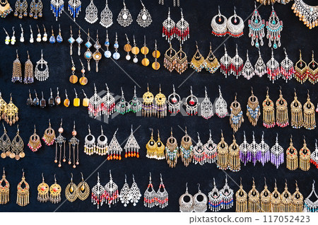 oriental Uzbek earrings in arabic ethnic style on black background in Uzbekistan oriental Uzbek earrings in arabic ethnic style on black background in Uzbekistan 117052423