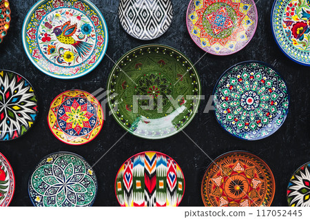 oriental Uzbek ceramic plates hand-painted on black background in Uzbekistan oriental Uzbek ceramic plates hand-painted on black background in Uzbekistan 117052445