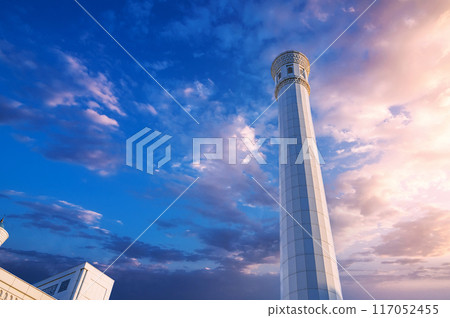 white minaret of modern new Islamic Masjid Minor Mosque in Tashkent in Uzbekistan on background of beautiful sky 117052455
