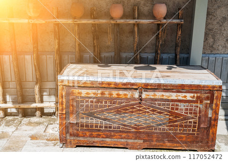 old traditional vintage Uzbek wooden chest with metal pattern on the street old traditional vintage Uzbek wooden chest with metal pattern on the street 117052472