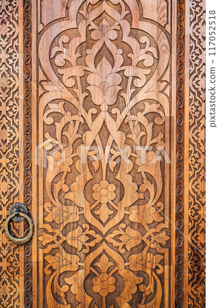 traditional Arabic Uzbek Islamic patterns arabesque ornament on an modern wooden carved door traditional Arabic Uzbek Islamic patterns arabesque ornament on an modern wooden carved door 117052518
