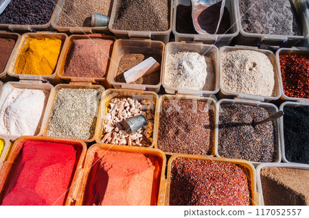 assortment of various oriental spices on the counter at the uzbek bazaar in Uzbekistan in Central Asia assortment of various oriental spices on the counter at the uzbek bazaar in Uzbekistan in Central Asia 117052557