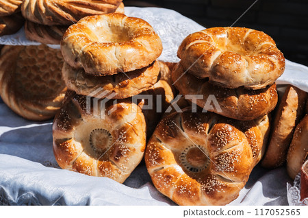 traditional Asian oriental bread Uzbek tandoor flatbread on the counter at bazaar in Uzbekistan traditional Asian oriental bread Uzbek tandoor flatbread on the counter at bazaar in Uzbekistan 117052565