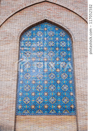 ceramic tile with traditional Uzbek ornament Arabic Islamic pattern on wall of old ancient Muslim mosque Hazrati Imam in Uzbekistan in Tashkent 117052582